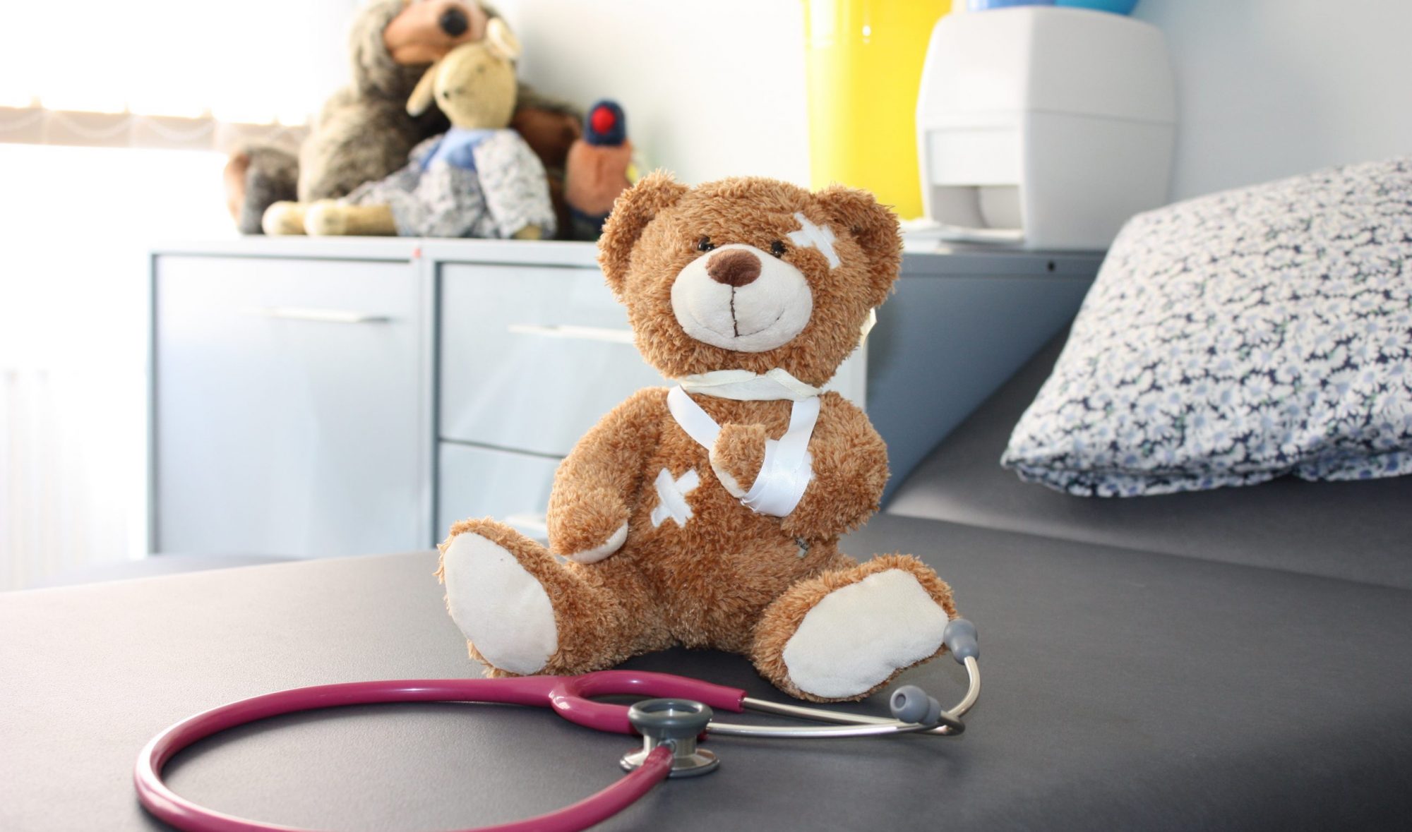 Teddybär mit Stethoskop im Behandlungsraum